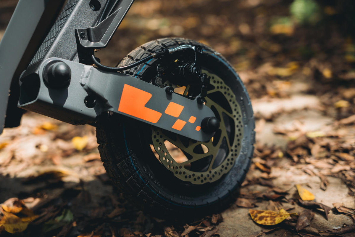 Close-up of KuKirin G2 front disc brake and tubeless tire.