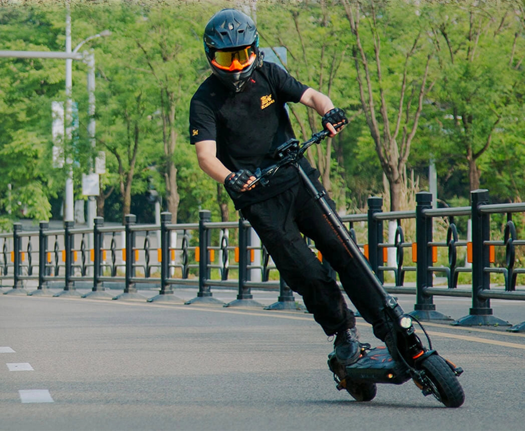 KuKirin G2 Master electric scooter riding fast on an open paved road.