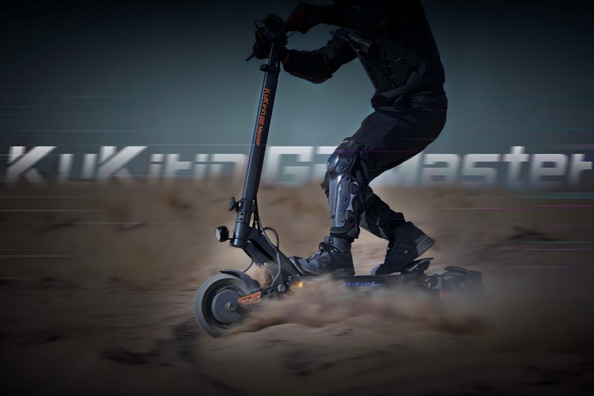 High-performance KuKirin G2 Master dual-motor scooter racing on a desert sand trail.