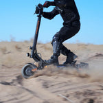 KuKirin G2 Master dual-motor off-road scooter drifting in desert sand.