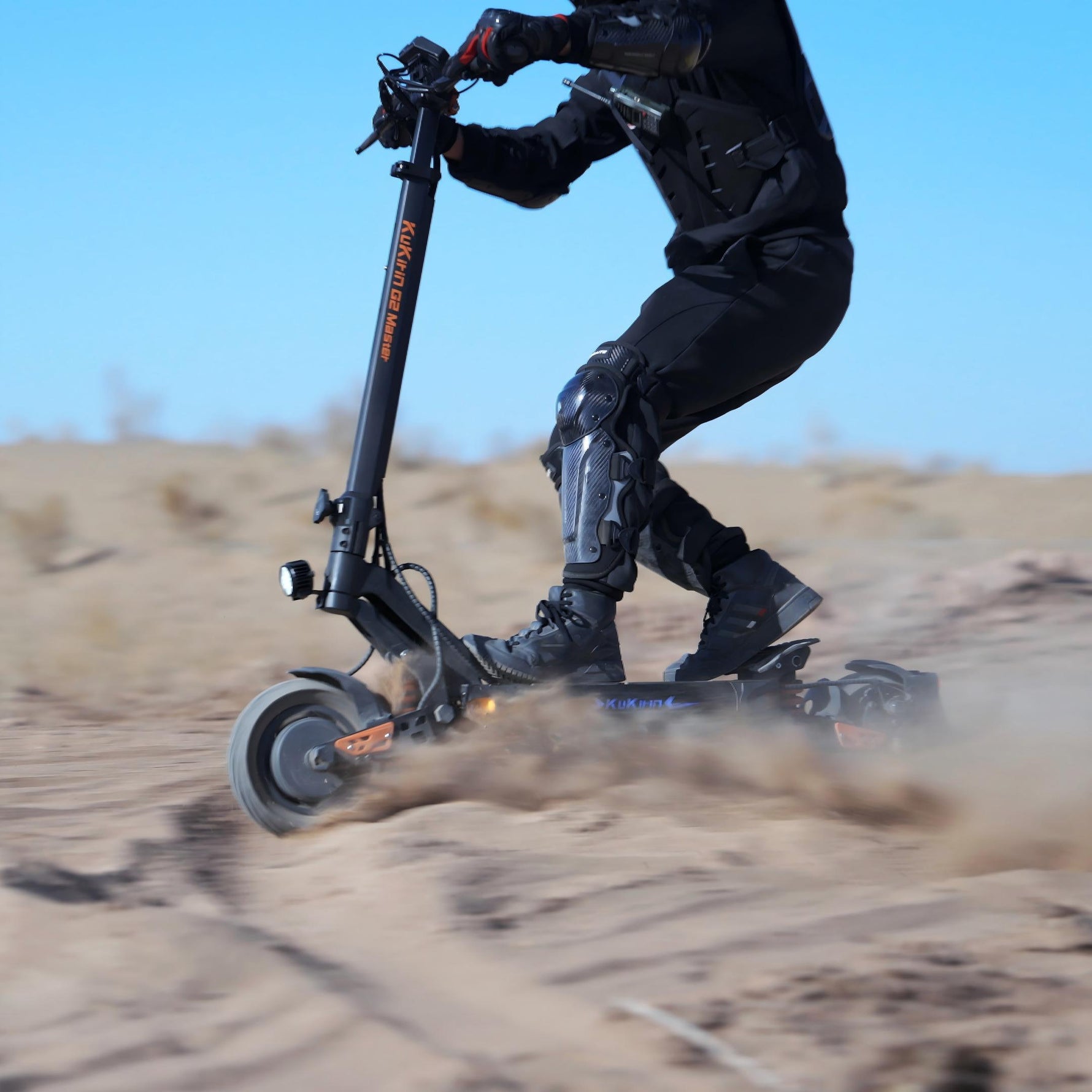KuKirin G2 Master dual-motor off-road scooter drifting in desert sand.