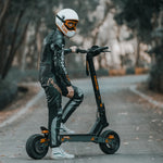 Rider posing with the KuKirin G4 electric scooter on a paved road